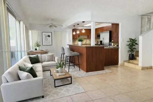 a living room with furniture and a large window