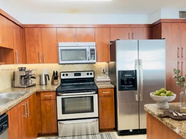 a kitchen with a refrigerator sink and stove