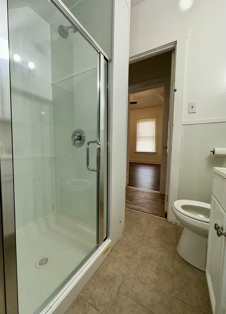 10749 South State Street Chicago, IL 60628 - Photo 24 of 31 a bathroom with a shower and a toilet