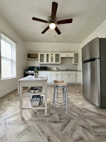 10749 South State Street Chicago, IL 60628 - Photo 25 of 31 a living room with stainless steel appliances kitchen island granite countertop furniture and a kitchen view