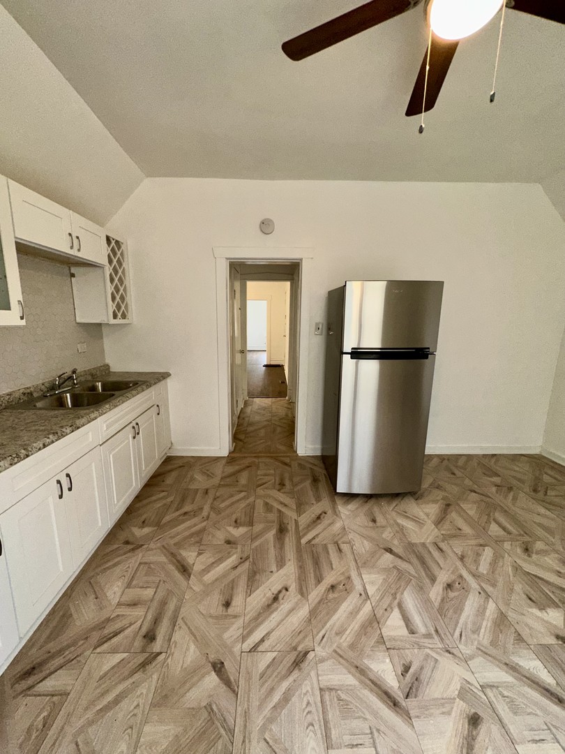 10749 South State Street Chicago, IL 60628 - Photo 27 of 31 a view of a kitchen with a refrigerator
