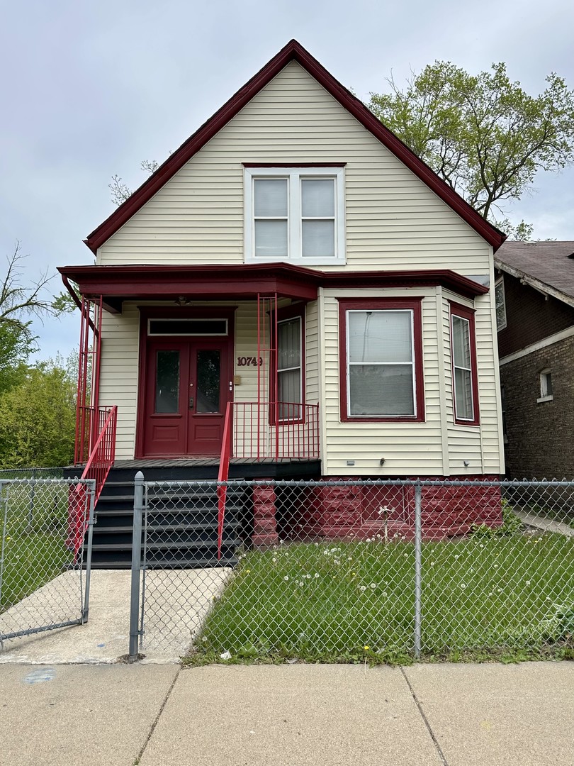 10749 South State Street Chicago, IL 60628 - Photo 3 of 31 a front view of a house with garage