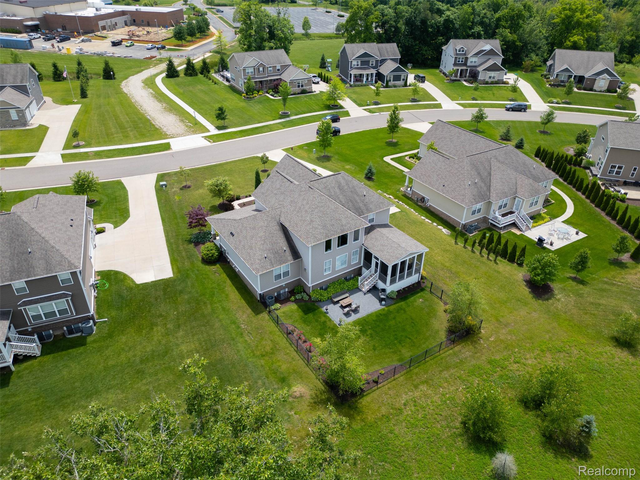 2531 Walnut View Drive Howell, MI 48855 - Photo 33 of 34 Residential property featuring a spacious backyard, screened-in porch, and stone patio