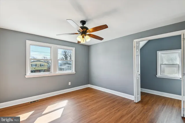 wooden floor in an empty room with a window
