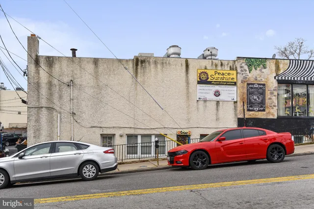 a front view of a building with retail shops