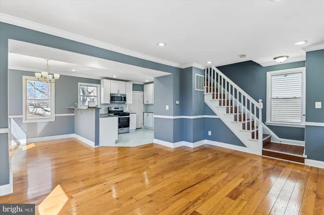 a view of kitchen with wooden floor and seating area