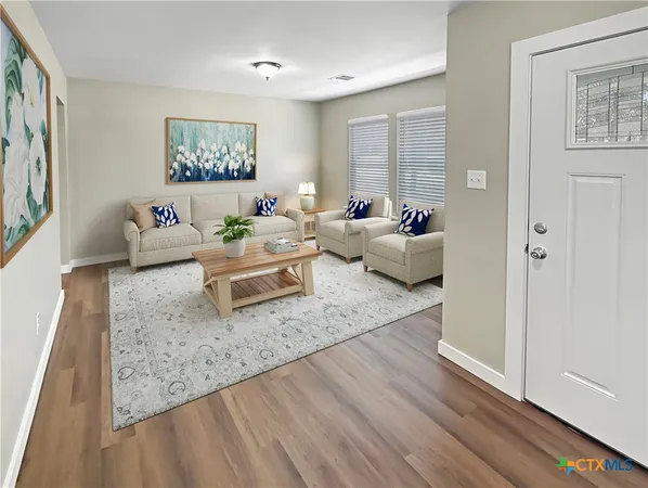 a living room with furniture and a table