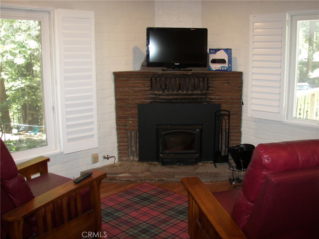 1101 Big Tree Lane Crestline, CA 92325 - Photo 22 of 30 a living room with furniture and a fireplace