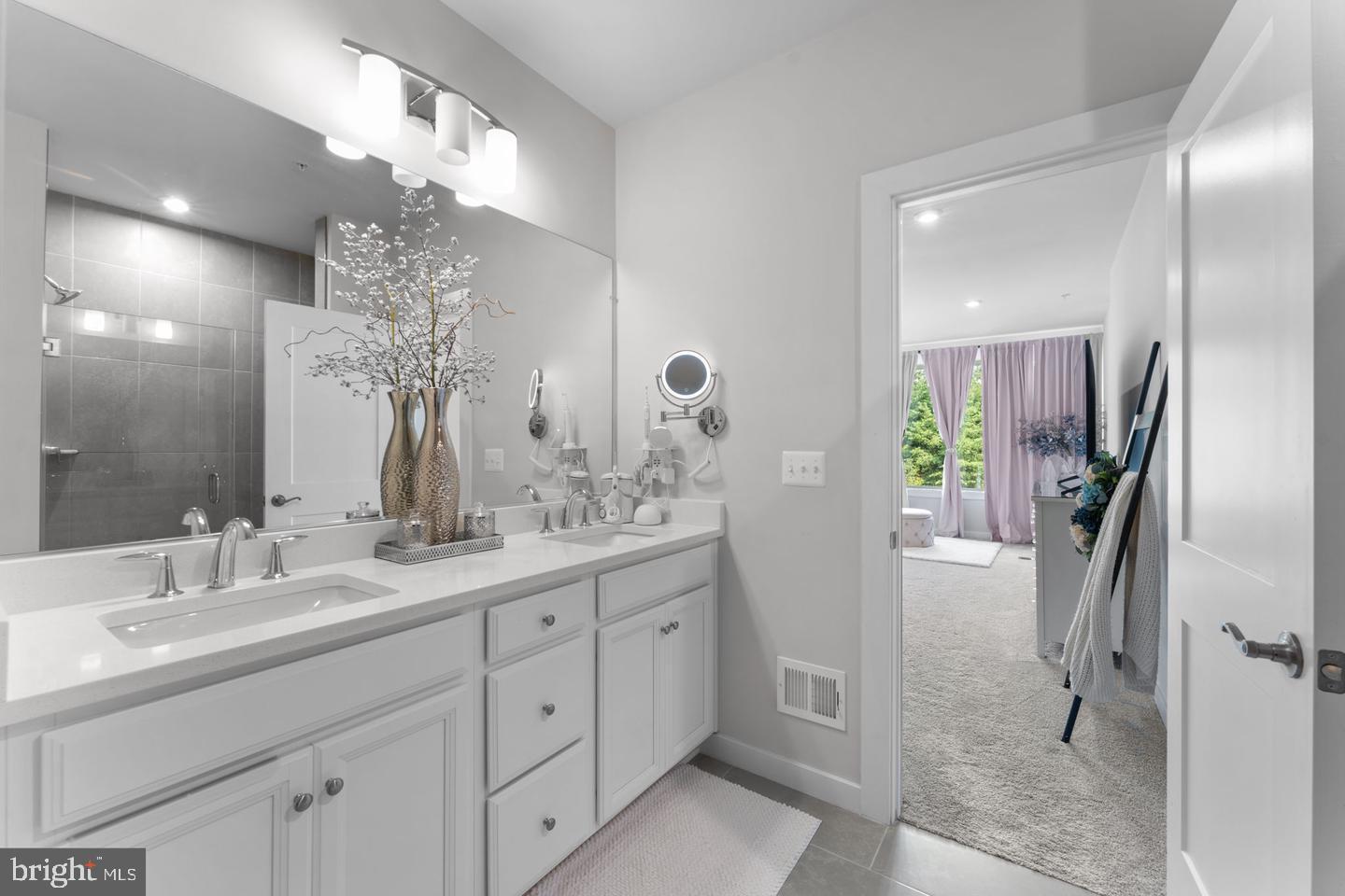 43785 Transit Square Ashburn, VA 20147 - Photo 15 of 40 a spacious bathroom with a granite countertop sink a mirror and a shower