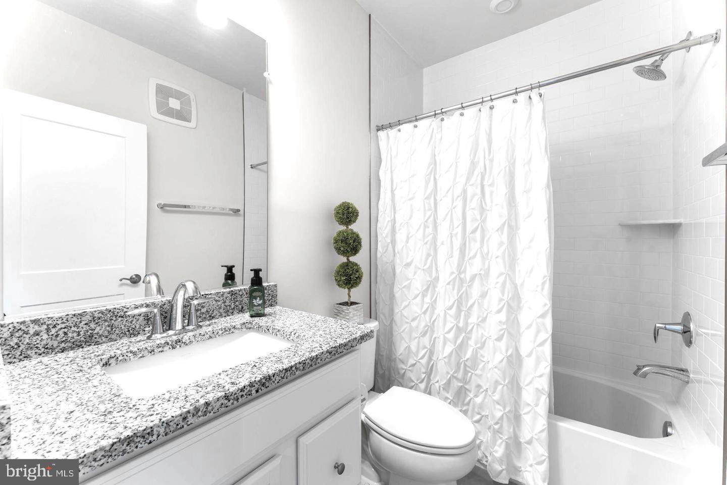 43785 Transit Square Ashburn, VA 20147 - Photo 21 of 40 a bathroom with a granite countertop sink and a mirror