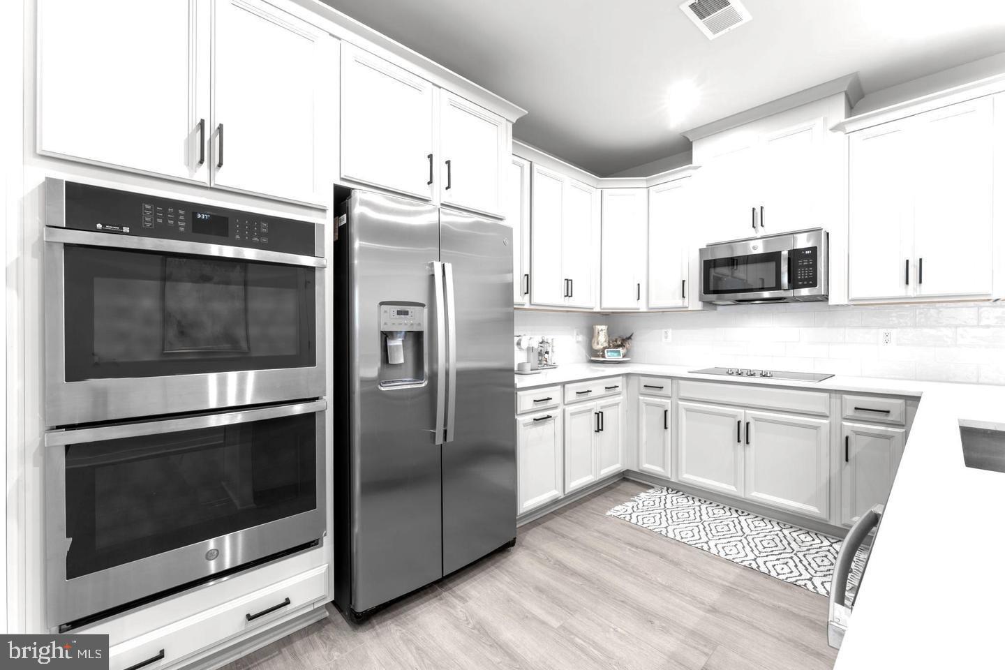 43785 Transit Square Ashburn, VA 20147 - Photo 7 of 40 a kitchen with granite countertop stainless steel appliances and wooden cabinets