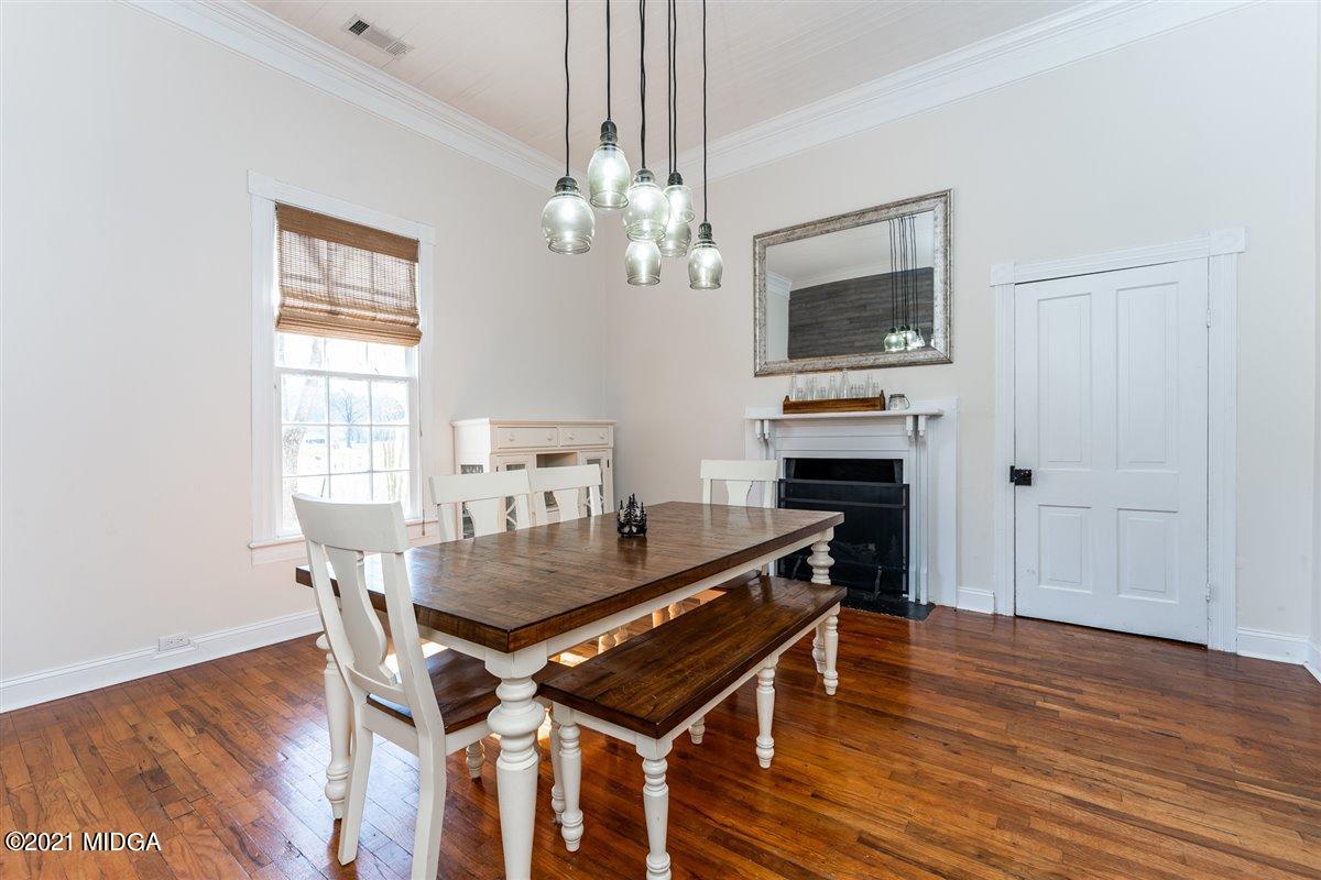 96 Gose Road Forsyth, GA 31029 - Photo 11 of 38 a view of a dining room with furniture a chandelier and wooden floor
