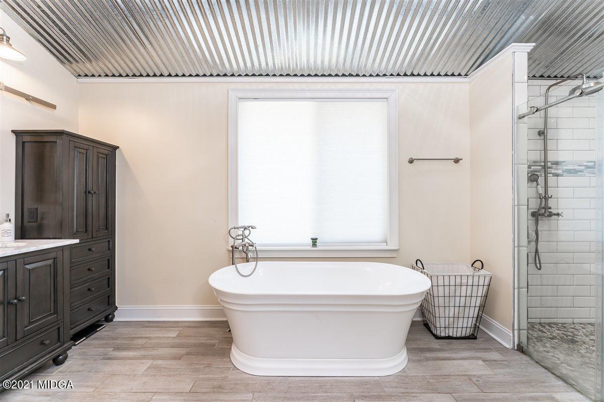96 Gose Road Forsyth, GA 31029 - Photo 17 of 38 a bathroom with a bathtub and shower