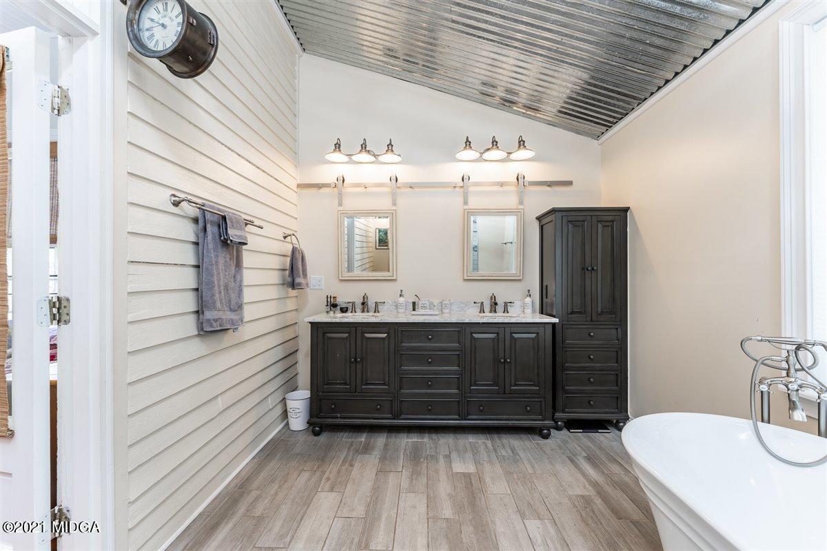 96 Gose Road Forsyth, GA 31029 - Photo 18 of 38 a bathroom with a sink a mirror and shower