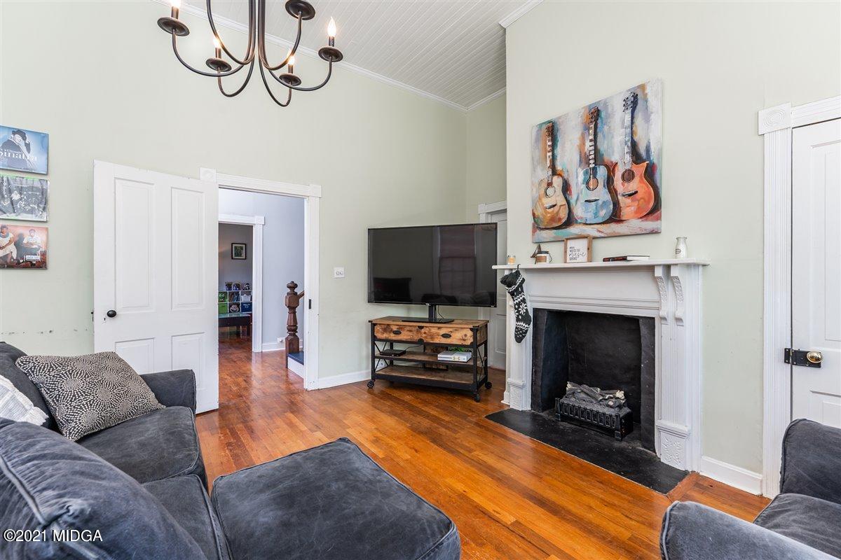 96 Gose Road Forsyth, GA 31029 - Photo 28 of 38 a living room with furniture a flat screen tv and a fireplace
