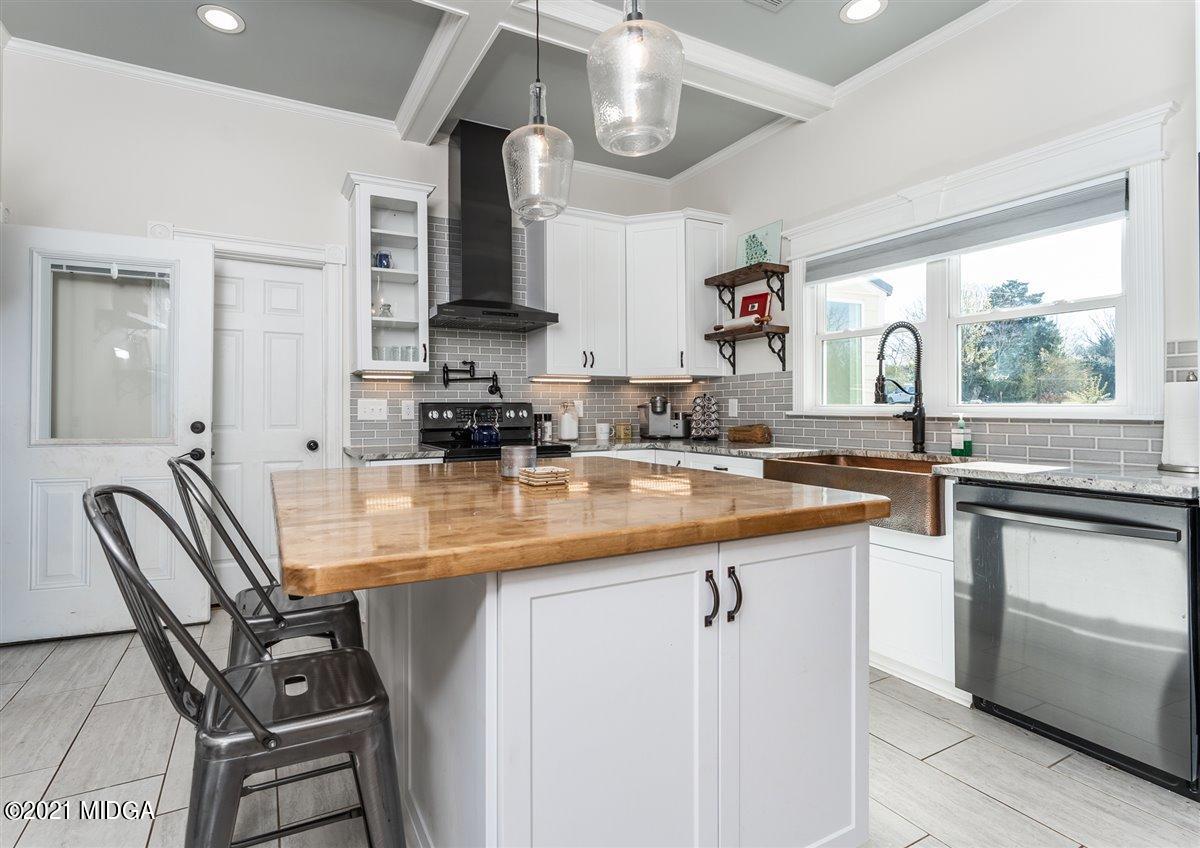 96 Gose Road Forsyth, GA 31029 - Photo 6 of 38 a kitchen with stainless steel appliances granite countertop a sink stove and cabinets