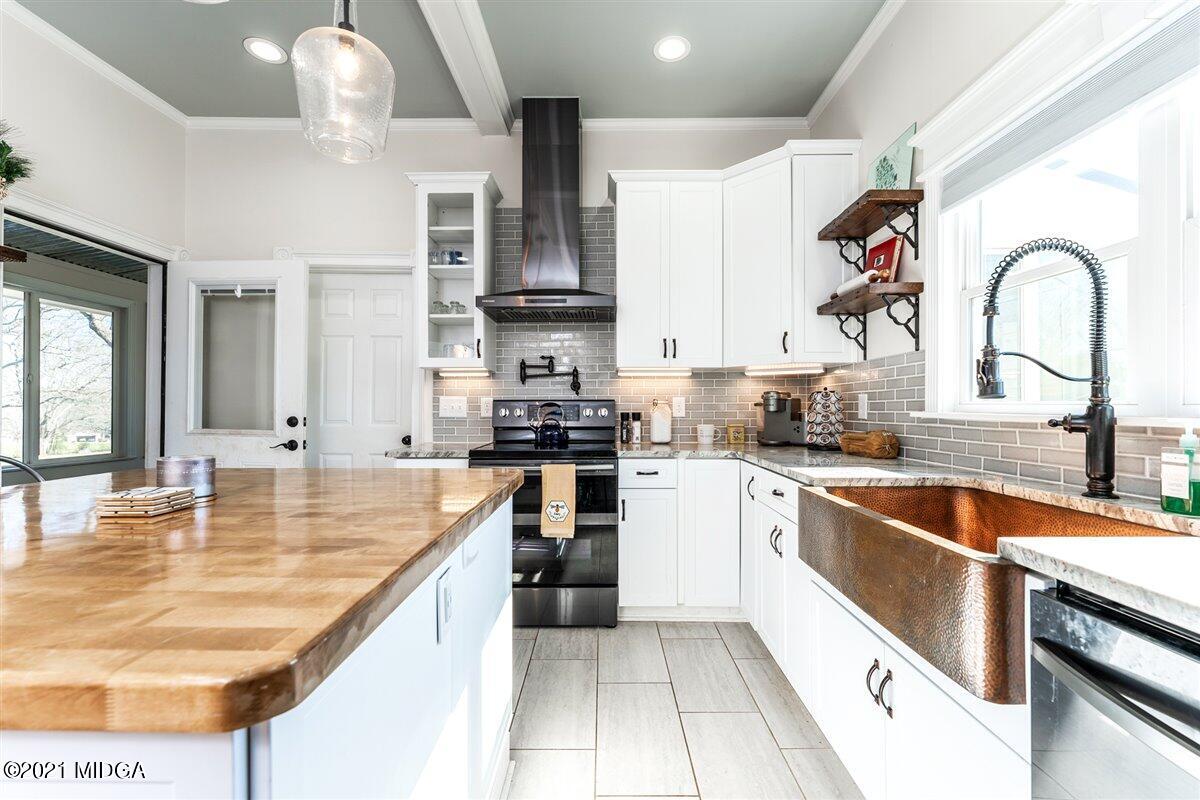 96 Gose Road Forsyth, GA 31029 - Photo 7 of 38 a kitchen with kitchen island granite countertop a sink appliances cabinets and a counter top space