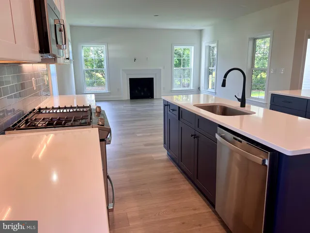 a kitchen with granite countertop a stove and a sink