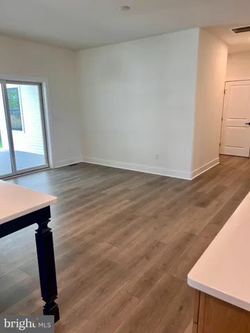 a view of a room with wooden floor