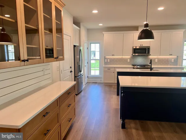 a open kitchen with granite countertop a stove and a sink