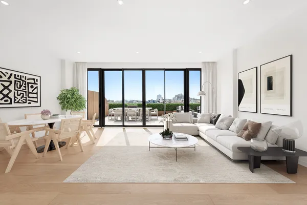 a living room with furniture large windows a rug and white walls