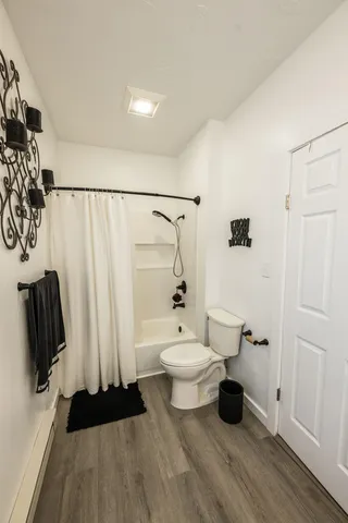 a bathroom with a toilet a sink and shower