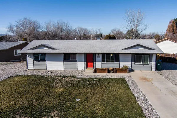 a front view of a house with small garden