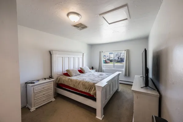 a bed room with a bed and window