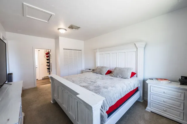 a bedroom with a bed and a dresser