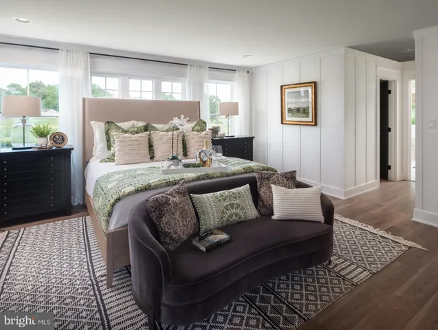 a bedroom with a bed rug and window