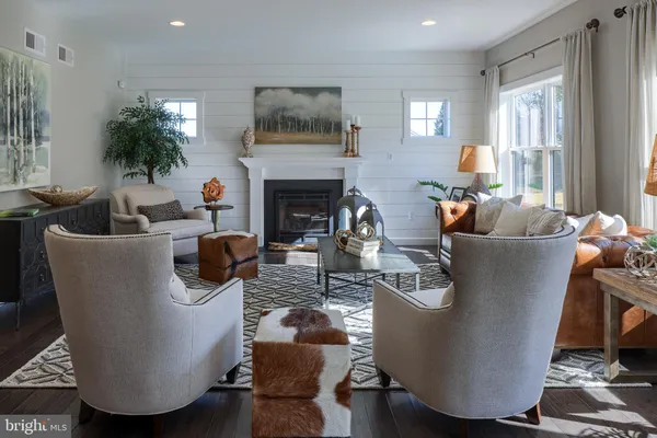 a living room with furniture a chandelier and a fireplace