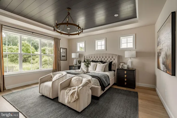 a spacious bedroom with a bed a window and walk in closet