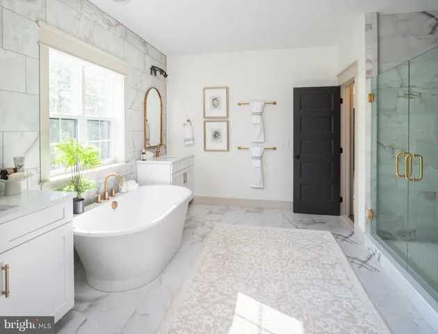 a spacious bathroom with a bathtub and sink