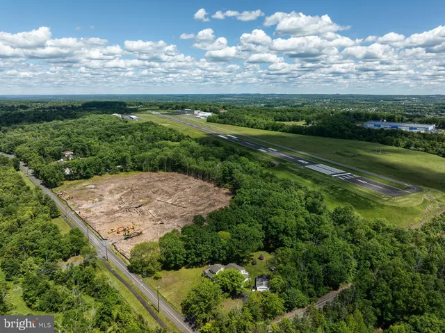 an aerial view of a golf course with a lake view