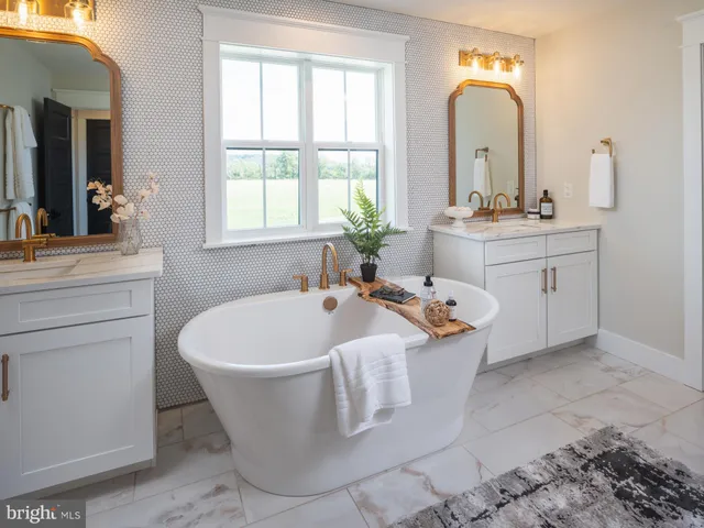 a spacious bathroom with a bathtub sink and mirror
