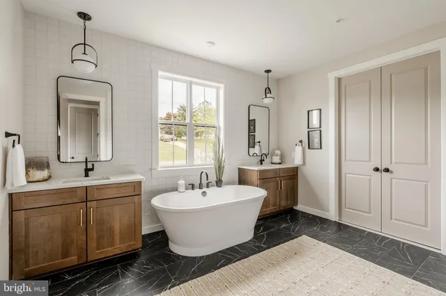 a view of a bathroom with 2 sink mirror and window