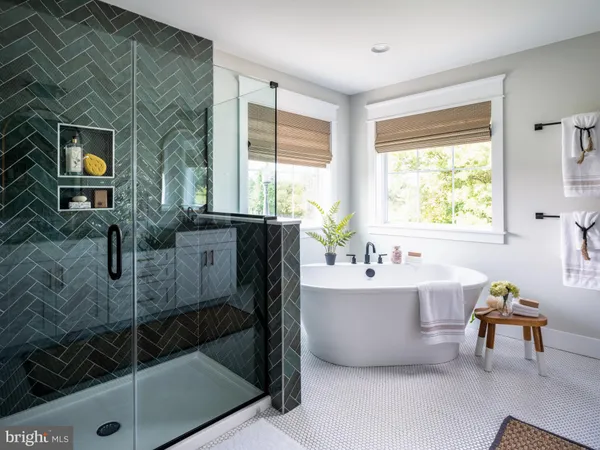 a spacious bathroom with a tub sink and mirror