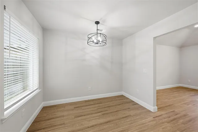 a view of a room with wooden floor and window
