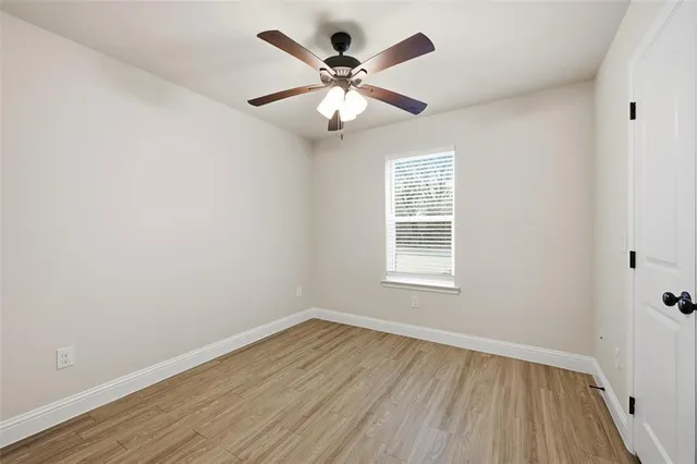 wooden floor in an empty room with a window