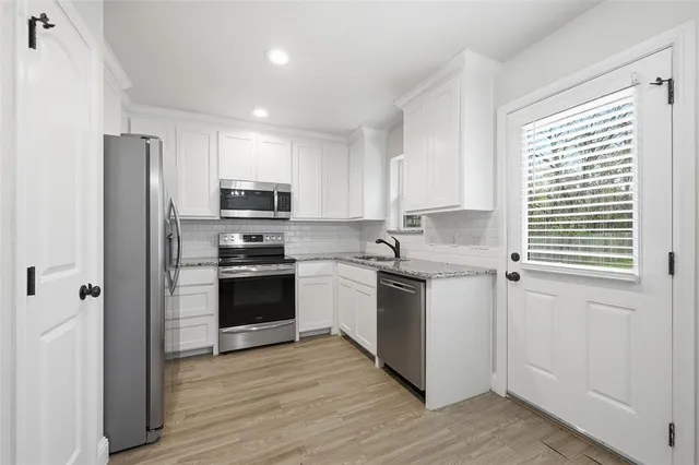 a kitchen with a refrigerator stove and microwave