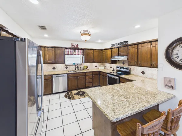 a kitchen with a sink stove top oven and cabinets