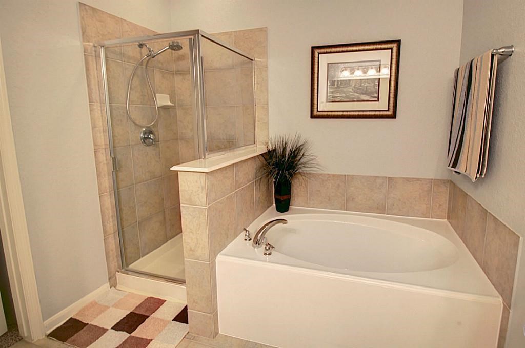 1246 Glenwood Canyon Lane Houston, TX 77077 - Photo 13 of 21 a bathroom with a bathtub and a shower