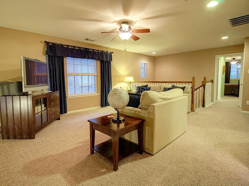 1246 Glenwood Canyon Lane Houston, TX 77077 - Photo 14 of 21 a living room with furniture and a flat screen tv