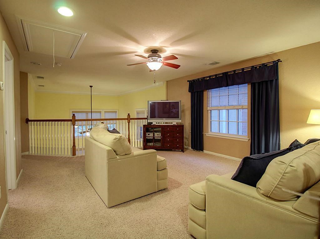 1246 Glenwood Canyon Lane Houston, TX 77077 - Photo 15 of 21 a living room with furniture and a flat screen tv