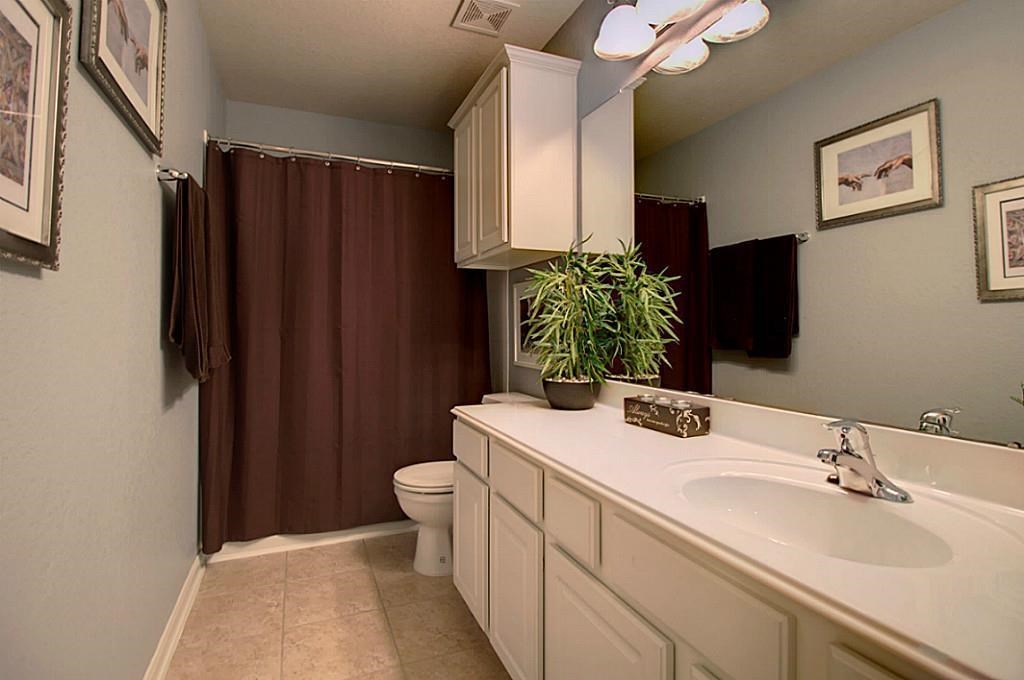 1246 Glenwood Canyon Lane Houston, TX 77077 - Photo 17 of 21 a bathroom with a sink toilet and shower