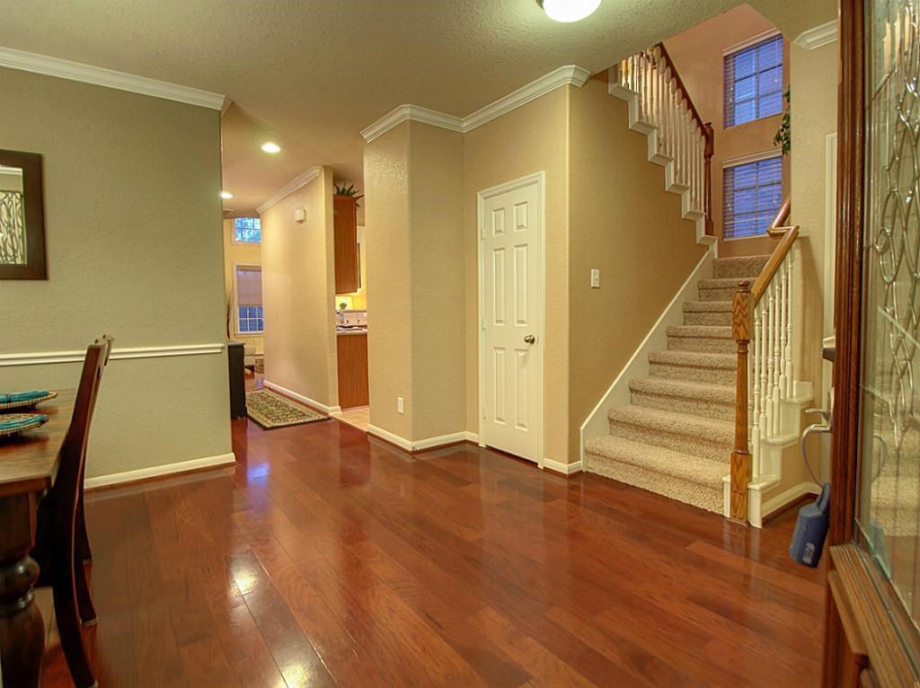 1246 Glenwood Canyon Lane Houston, TX 77077 - Photo 2 of 21 a view of a hallway with wooden floor and staircase