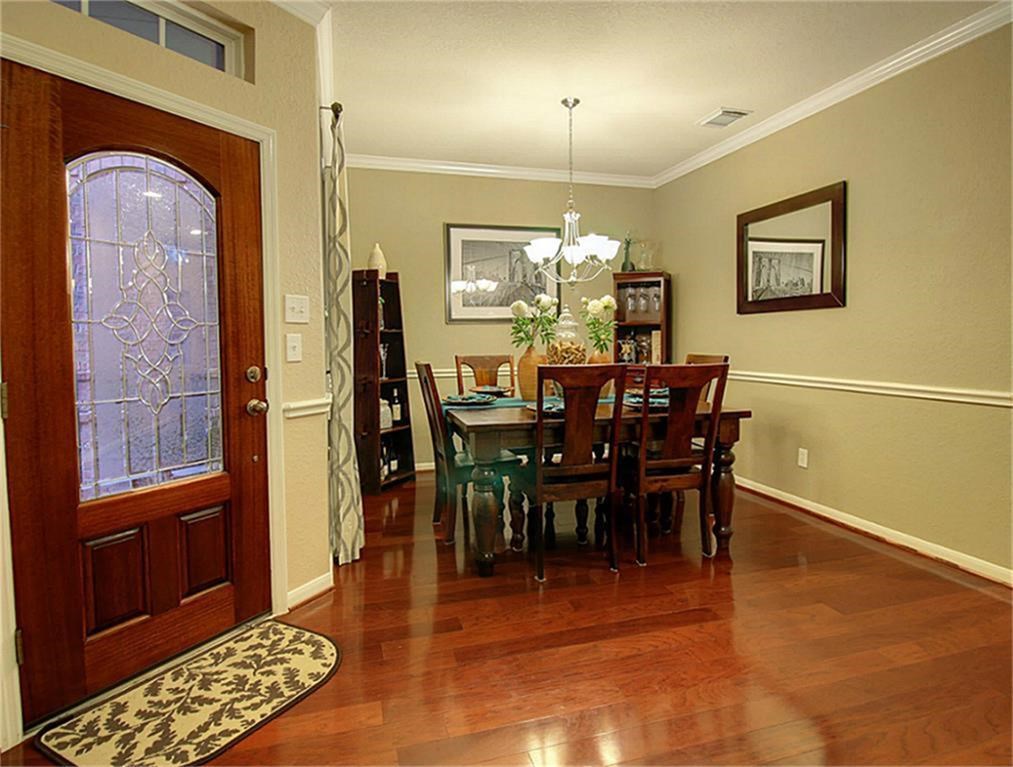 1246 Glenwood Canyon Lane Houston, TX 77077 - Photo 3 of 21 a view of a dining room with furniture and chandelier
