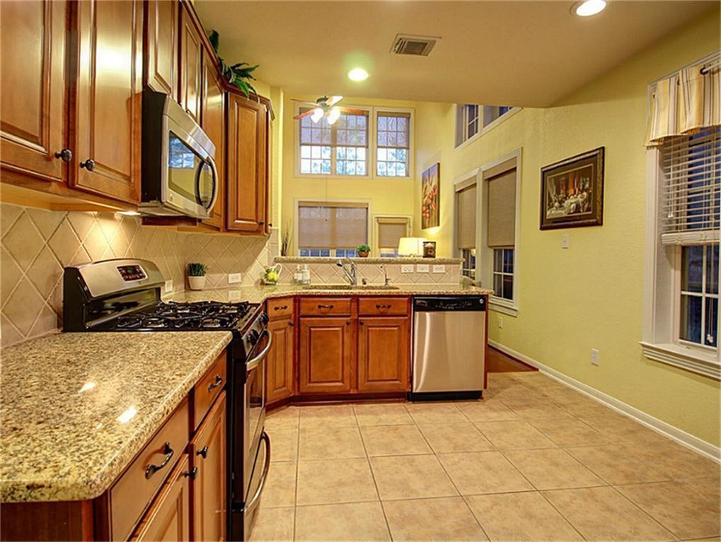 1246 Glenwood Canyon Lane Houston, TX 77077 - Photo 7 of 21 a kitchen with stainless steel appliances granite countertop a stove a sink and a microwave