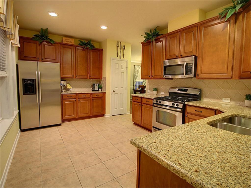 1246 Glenwood Canyon Lane Houston, TX 77077 - Photo 8 of 21 a kitchen with stainless steel appliances granite countertop a sink a stove and a refrigerator