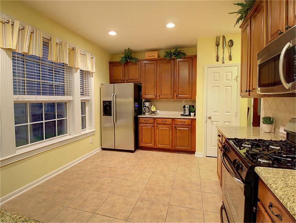 1246 Glenwood Canyon Lane Houston, TX 77077 - Photo 9 of 21 a kitchen with stainless steel appliances granite countertop a stove a sink and a refrigerator